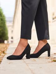 Model wearing Agenda black faux suede square toe court heels