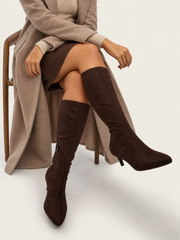 Model wearing Horizon wide fit brown faux suede high leg boots with a camel coat