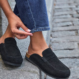 Model wearing Poet black real suede mule loafers with jeans
