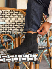 Model wearing Tailored wide fit black faux suede low heel ankle boots